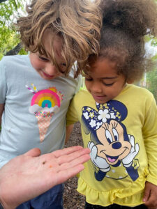 two kids looking at hand
